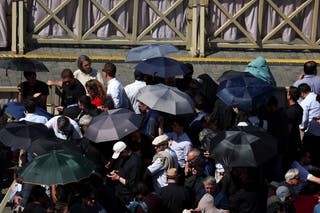 People use umbrellas to protect from sun in St. Petrova Square